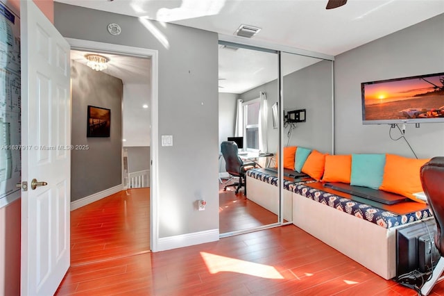 living room featuring hardwood / wood-style flooring and ceiling fan