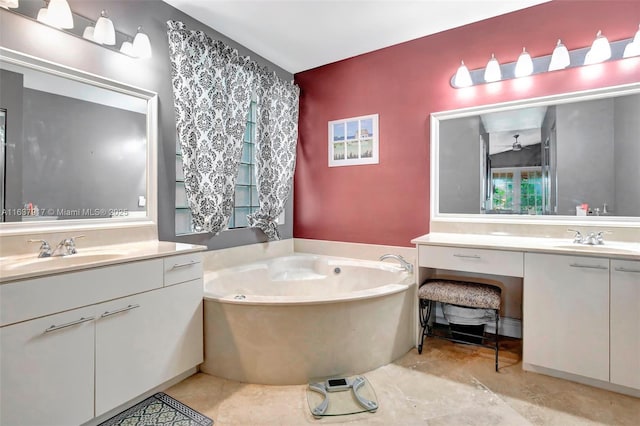 bathroom featuring a washtub, ceiling fan, and vanity