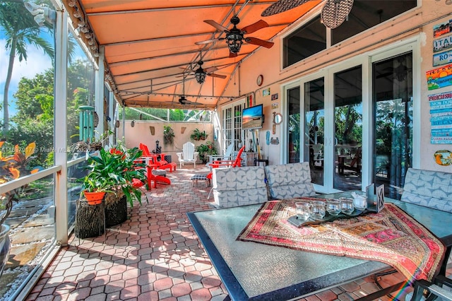 exterior space featuring ceiling fan and vaulted ceiling