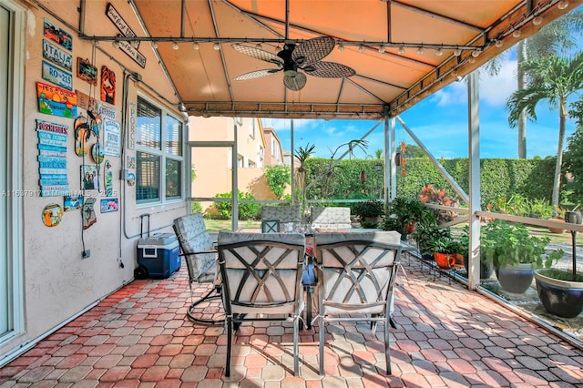 sunroom with a wealth of natural light and ceiling fan