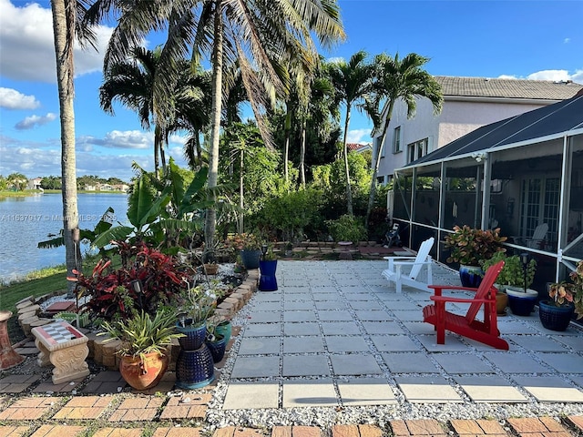 view of patio featuring a water view and a lanai