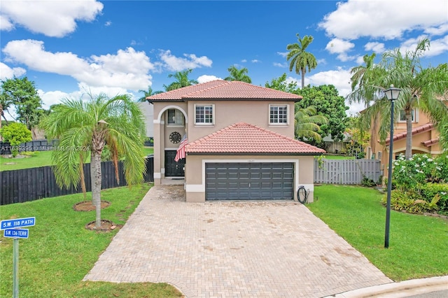 mediterranean / spanish-style home with a front yard and a garage