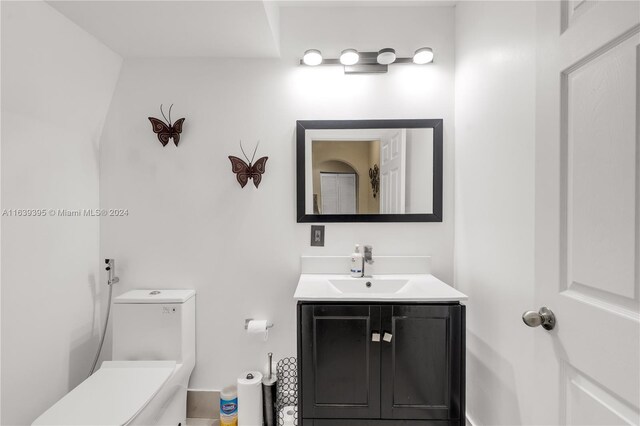 bathroom featuring toilet and vanity