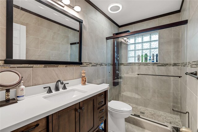 bathroom with tile walls, toilet, tile patterned floors, vanity, and walk in shower