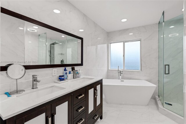 bathroom featuring tile walls, shower with separate bathtub, double vanity, and tile patterned flooring