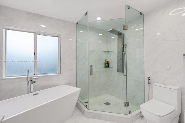 bathroom with a shower with shower door, tile walls, tile patterned floors, and toilet