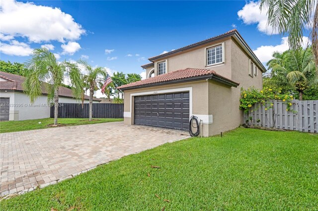 view of front of property with a garage and a front yard