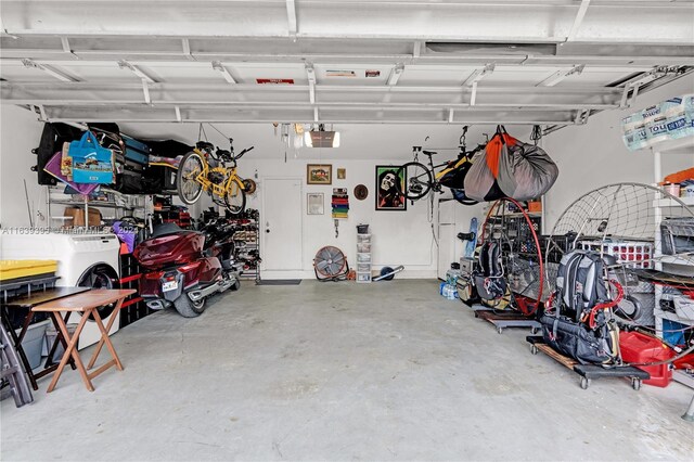 garage featuring washing machine and clothes dryer and a garage door opener