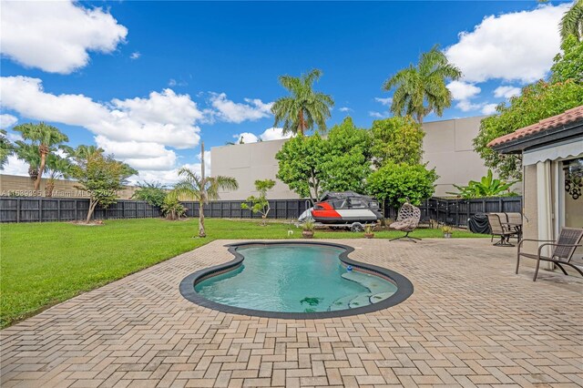 view of swimming pool featuring a patio area and a lawn