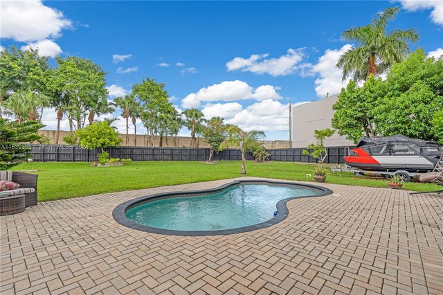 view of pool featuring a patio area and a yard