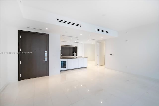 unfurnished living room featuring light tile patterned floors