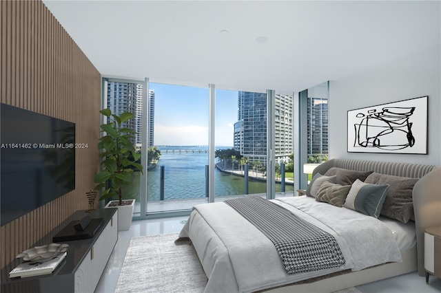 bedroom with access to exterior, a wall of windows, and a water view