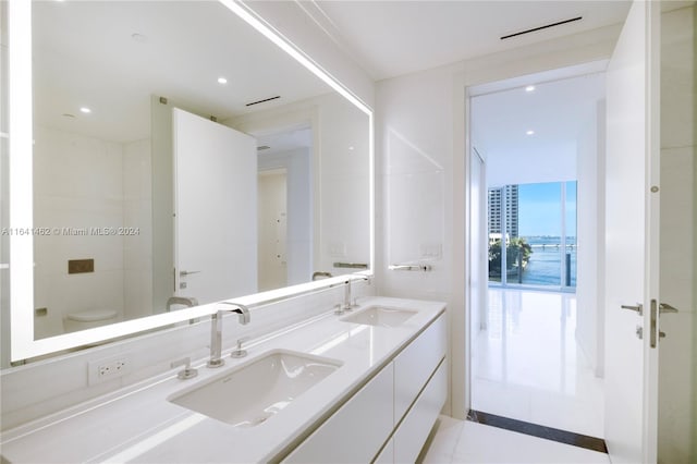 bathroom featuring toilet, vanity, and tile patterned flooring