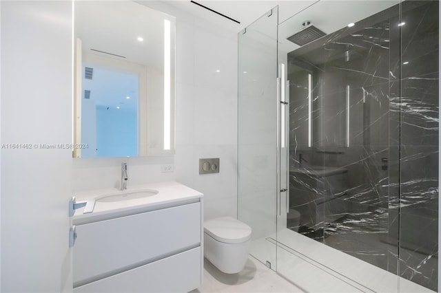 bathroom featuring a shower with door, vanity, and toilet