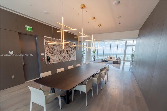 dining area featuring a notable chandelier and light wood-type flooring