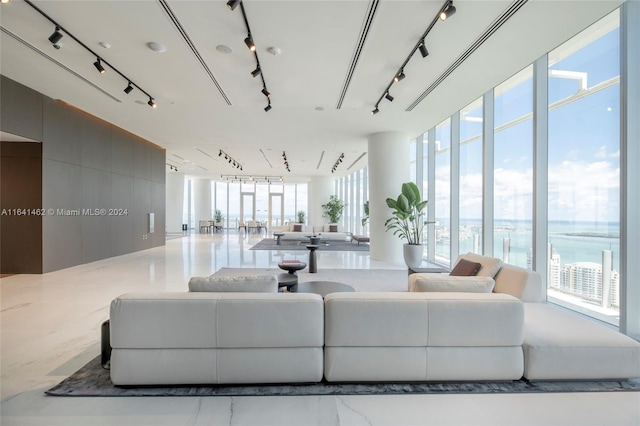 living room featuring a wealth of natural light and a water view