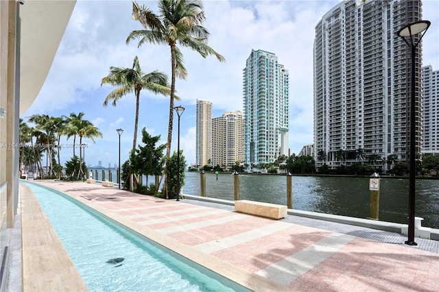 view of pool featuring a water view