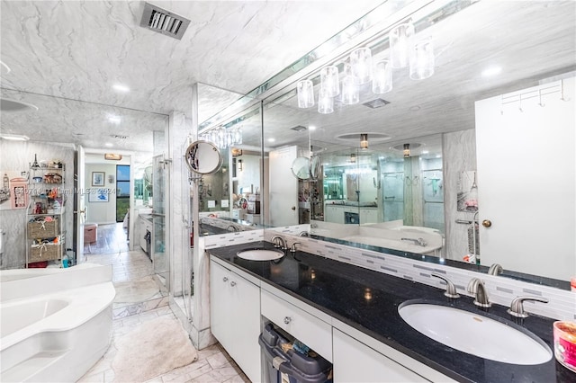 bathroom with shower with separate bathtub, dual vanity, and tile patterned floors