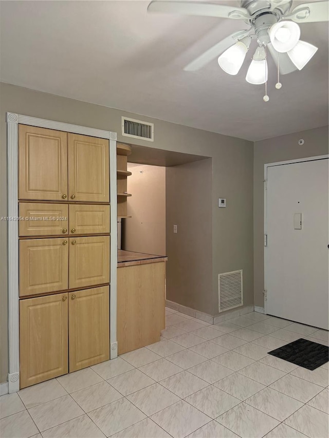 kitchen with ceiling fan, light tile patterned flooring, and light brown cabinets