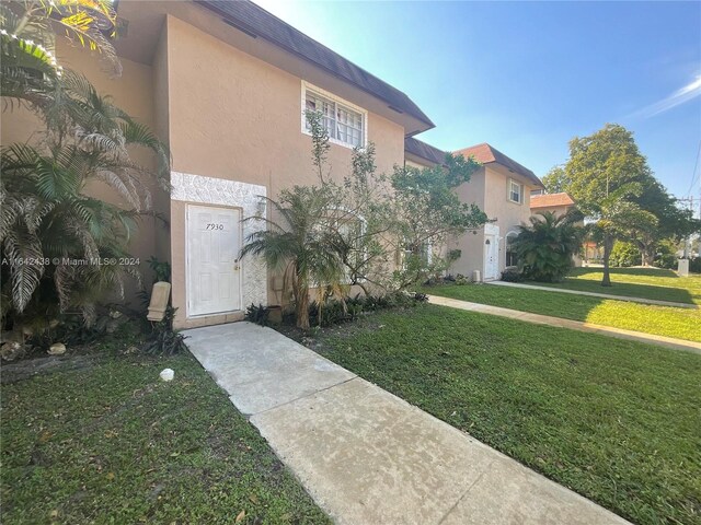 view of property exterior featuring a lawn