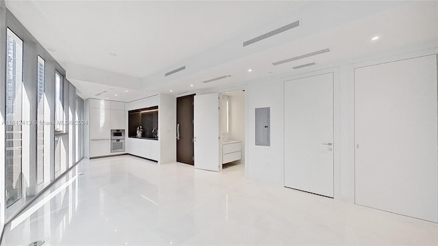 empty room with electric panel and light tile patterned floors