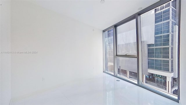 empty room featuring plenty of natural light and floor to ceiling windows