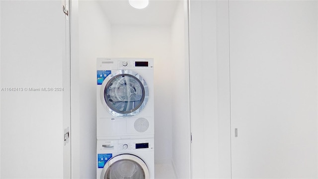 washroom featuring stacked washing maching and dryer