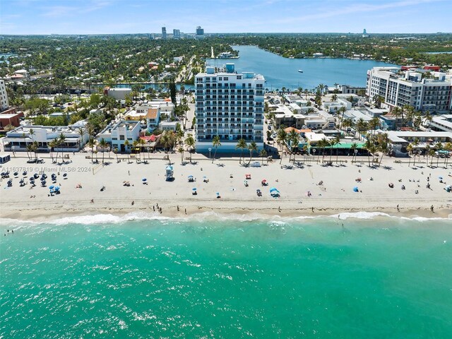 drone / aerial view with a beach view and a water view