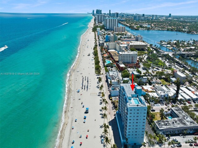 bird's eye view featuring a water view and a view of the beach