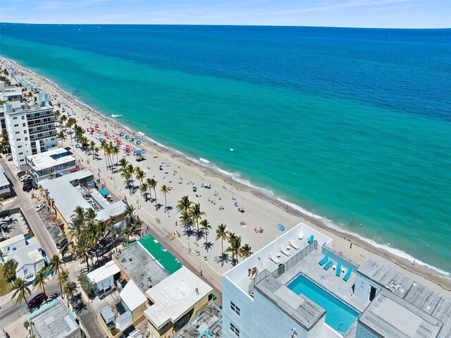 bird's eye view with a water view and a view of the beach