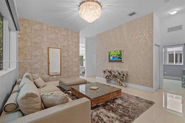 living room featuring light tile patterned floors and a notable chandelier