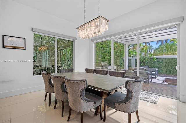 dining area featuring a chandelier and light tile patterned floors