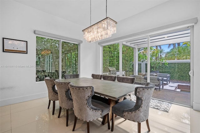 18935 Atlantic Blvd, Sunny Isles Beach, FL 33160 - tiled dining space featuring a chandelier and baseboards