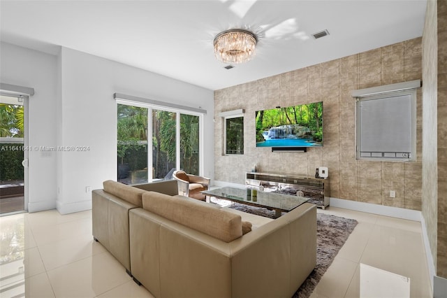 living room featuring tile walls, light tile patterned floors, and plenty of natural light