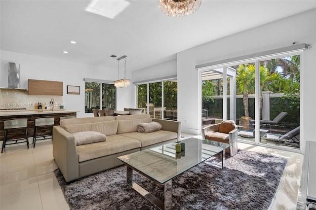 living room with a chandelier and light tile patterned floors