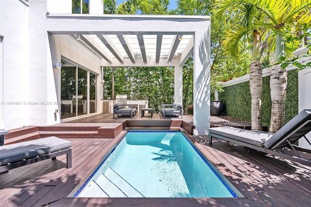 view of swimming pool featuring a pergola and a wooden deck