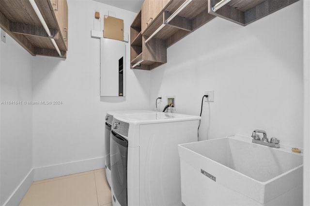 laundry area featuring sink, separate washer and dryer, cabinets, and tile patterned floors