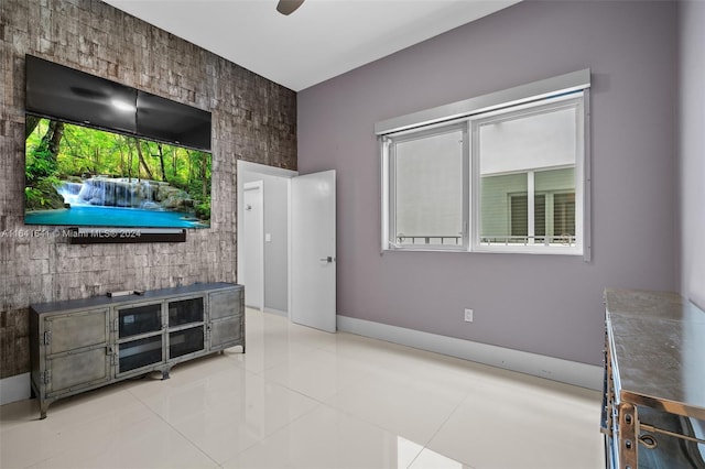 living room with ceiling fan and light tile patterned floors