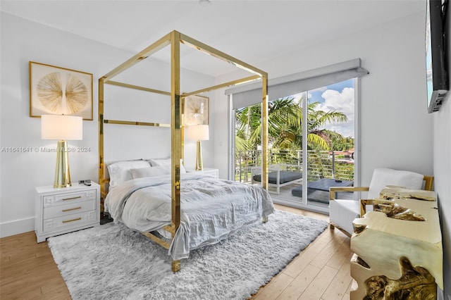 bedroom with access to outside and light hardwood / wood-style flooring