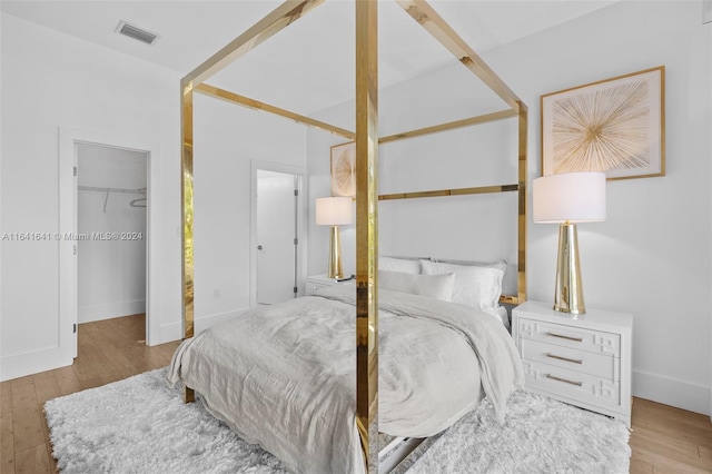 18935 Atlantic Blvd, Sunny Isles Beach, FL 33160 - bedroom with hardwood / wood-style flooring, a walk in closet, and a closet