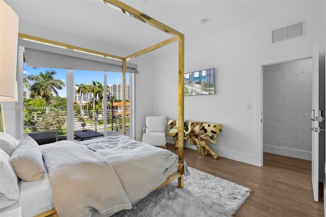 18935 Atlantic Blvd, Sunny Isles Beach, FL 33160 - bedroom with wood finished floors, baseboards, and access to exterior