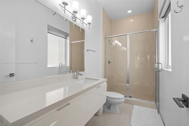 bathroom featuring a shower with door, toilet, tile patterned floors, and vanity