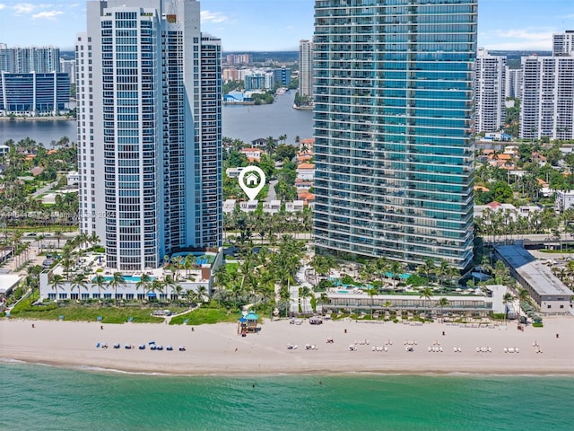 birds eye view of property with a view of the beach and a water view