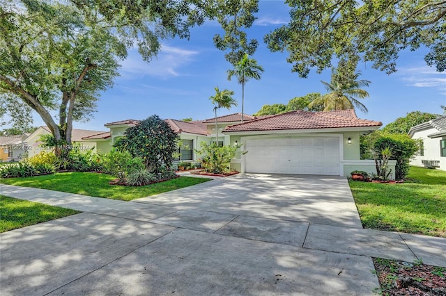 view of front of home with a garage and a front lawn