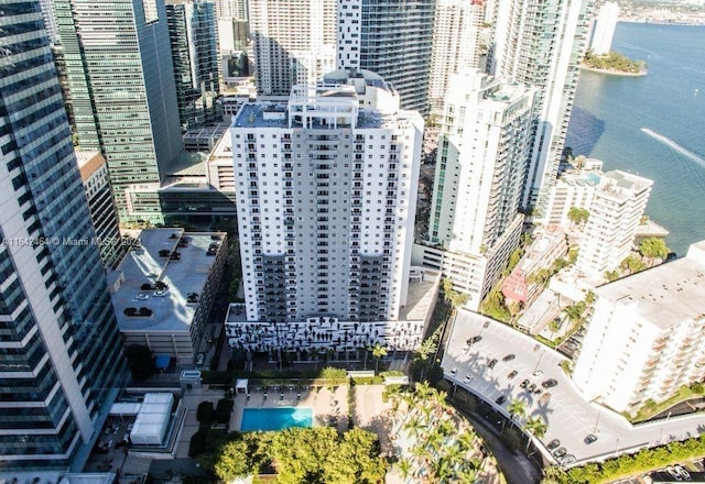 birds eye view of property with a water view and a view of city