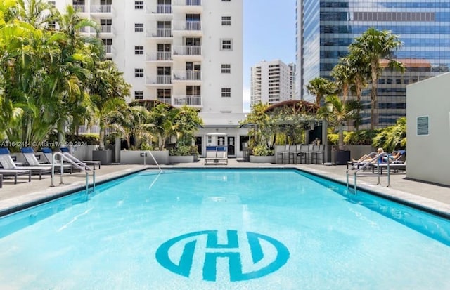 pool featuring a patio and fence