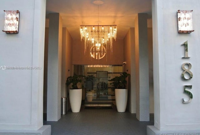 hallway featuring an inviting chandelier