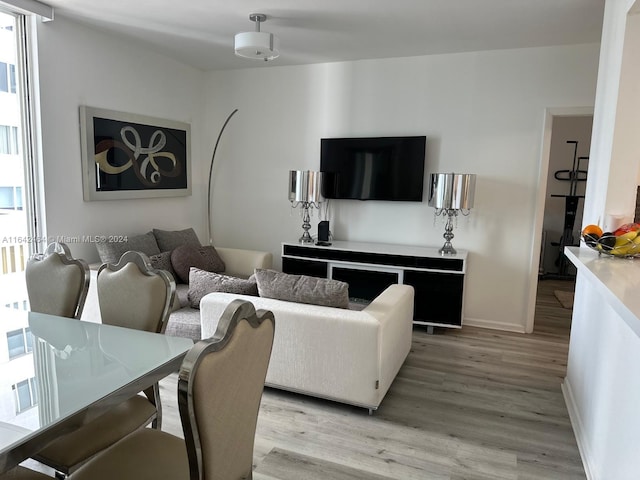 living room featuring light wood-style flooring and baseboards