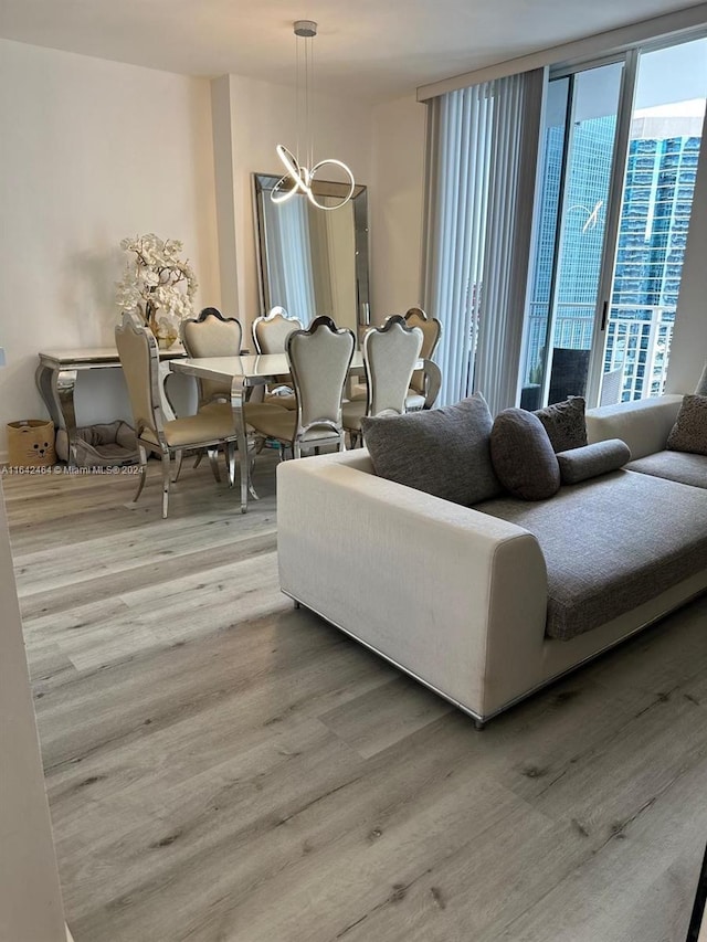 living area with an inviting chandelier and wood finished floors