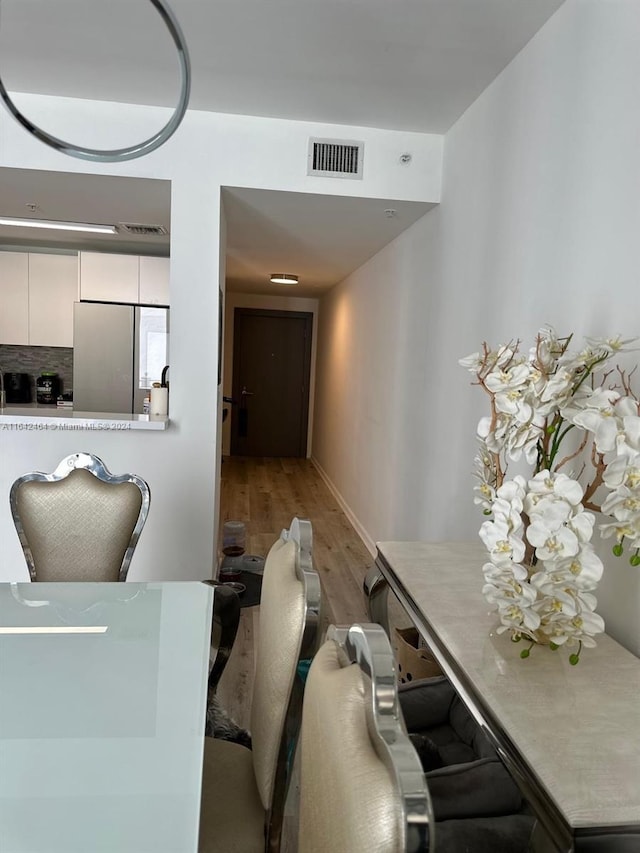 dining space with visible vents and wood finished floors